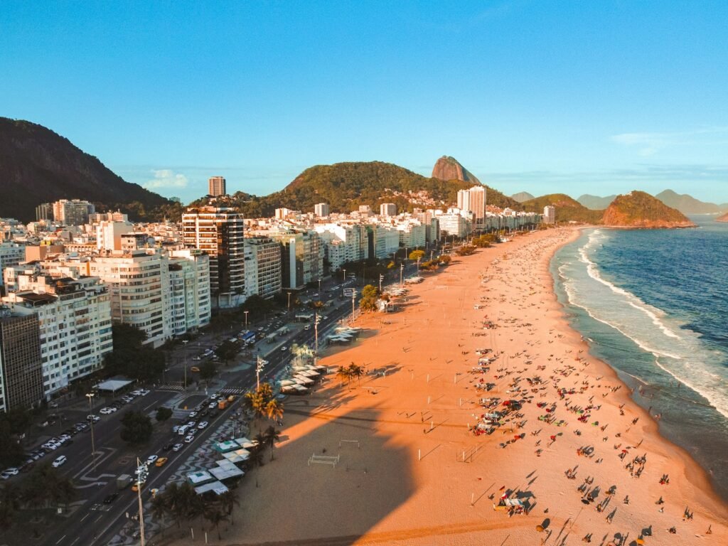 an aerial view of a beach with a city in the background - Rio de Janeiro