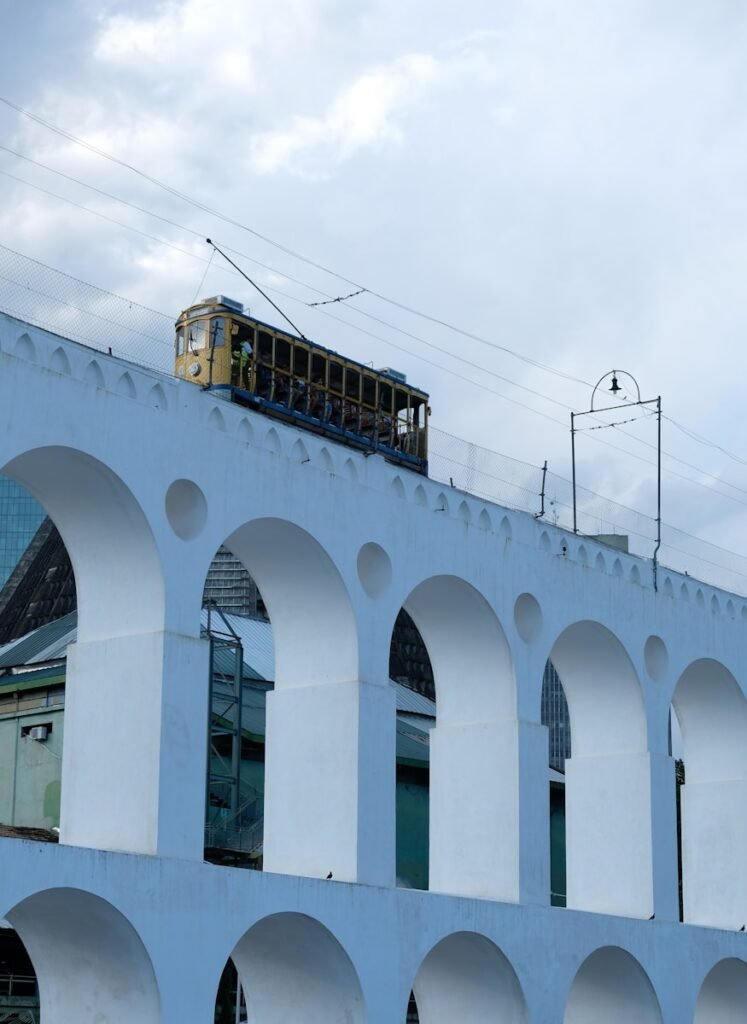 a train traveling over a bridge with arches - Rio de Janeiro