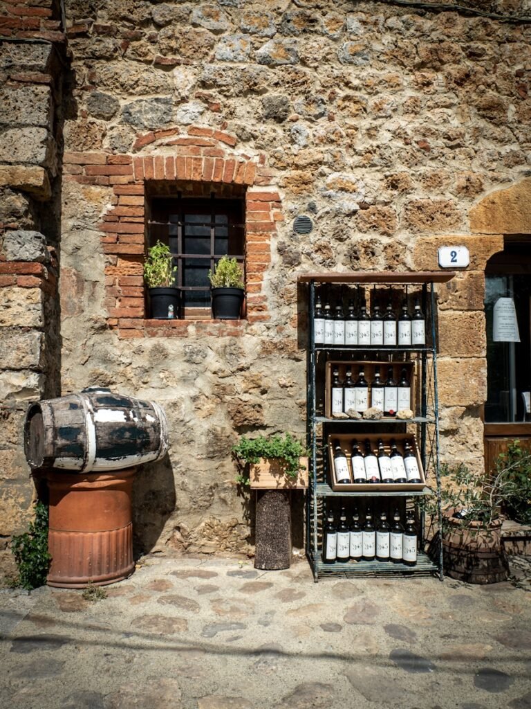 Toscana - Wine - a stone building with a wine rack and a barrel