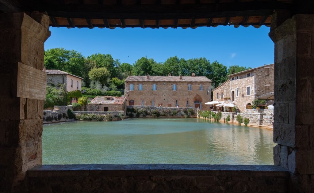 Bagno Vignoni - Toscana - A view of a body of water through a window